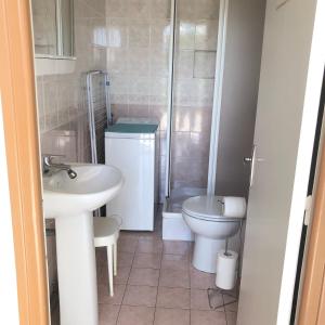 a small bathroom with a sink and a toilet at Halte Saltusienne in Saint-Julien-du-Sault