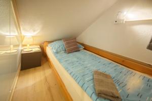 a small bedroom with a large bed in a room at Bio Ferienwohnung am Wildsee in Seefeld in Seefeld in Tirol