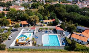 an aerial view of a house with a swimming pool at Camping Paradis 4 étoiles Au Port de L'Houmeau - La Rochelle in LʼHoumeau