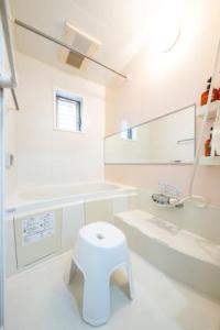 bagno bianco con servizi igienici e lavandino di 田端民泊ー田端ハウス a Tokyo