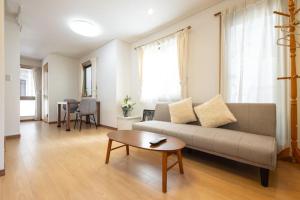 a living room with a couch and a table at 田端民泊ー田端ハウス in Tokyo