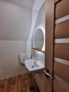 モイエチウ・デ・ススにあるGeoVilaのバスルーム(洗面台、ドアの隣の鏡付)
