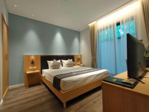 a bedroom with a bed and a desk with a computer at Hồng Gia Tuệ Lake View in Hanoi +49 photos