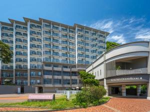 a large building with a sign in front of it at Atagawa Ocean Resort in Higashiizu