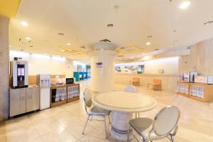 a room with a table and chairs in a store at Bell's Inn Tsuchiura in Tsuchiura