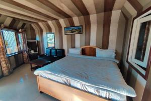 a bedroom with a large bed in a room at Hotel Surya Lake view in Nainital