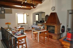a living room with a table and a fireplace at Bed & Breakfast In vino veritas in Arcevia