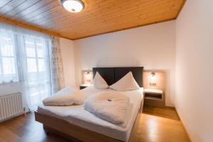 a bedroom with a bed with two pillows on it at Pension Walchauhof in Flachau