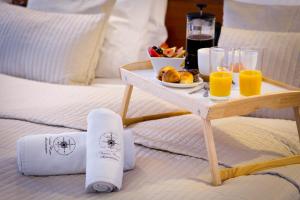 a bed with a tray of food and orange juice at B12 - Comfort Apartemnts City Center in Krakow