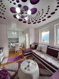 a living room with a couch and a table at APARTMAN PETRA Lux in Plužine