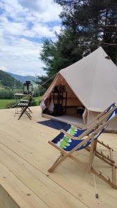 a tent with a chair and a table at Glamping-Dimbo in Krynica Zdrój