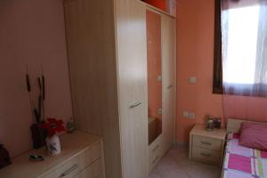 a bedroom with a bed and a dresser and a closet at Villa Periklis Madytos 1st Floor Independent House in Néa Mádhitos
