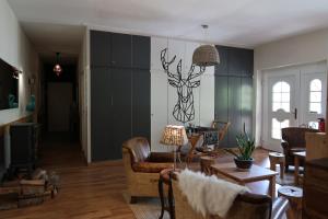 a living room with a drawing of a deer on the wall at Lodge Hotel Heiligendamm- digitales & rezeptionsloses Hotel in Heiligendamm