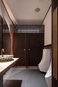 a bathroom with a toilet and a sink and a tub at Beanstalk Bangkok in Bangkok