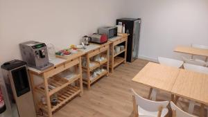 a room with a counter with a coffee maker and a refrigerator at Hotel SempreFisterra in Finisterre