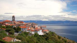 a town on top of a hill next to the water at VILLA STASJA in Brseč