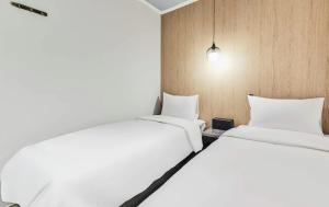 Postel nebo postele na pokoji v ubytování Hotel WO Yongsan Station