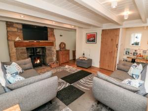 a living room with two couches and a fireplace at Stonewall in Whitby