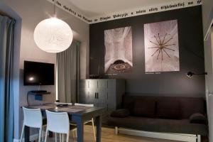 a dining room with a table and a couch at Patio Apartments - Old Town in Gdańsk