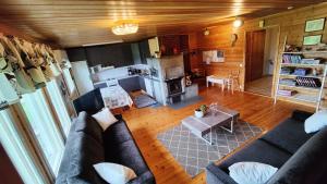 a living room with a couch and a fireplace at Maatilamatkailu Jänisvaara in Kolinkylä