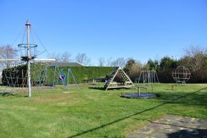 a park with a playground with a swing at Duinnest in Noordwijkerhout
