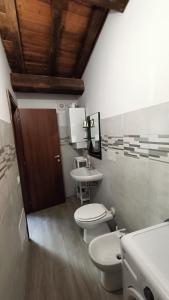 een badkamer met 2 toiletten en een wastafel bij Casetta Tipica in Borgo, indipendente, ristrutturata in LʼAquila