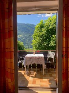 a table and chairs on a balcony with a view at Garni Rika in Parcines