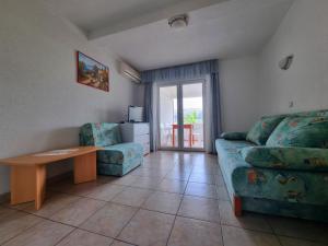 a living room with a couch and a table at Apartments Šešo in Pag