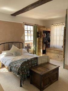 a bedroom with a bed and a table in it at Charming Cottage, Central Taunton. in Taunton