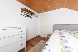 a bedroom with a bed and a wooden ceiling at Ferienhaus Sternenklar in Wittmund