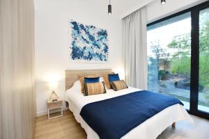 Llit o llits en una habitació de SHELLTER Apartament Green Dune – Rogowo