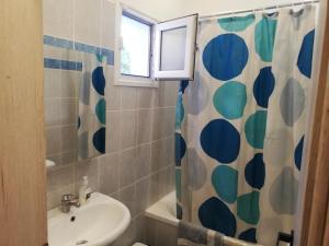 a bathroom with a sink and a shower curtain at Anestis Studios in Agios Georgios +52 photos