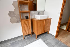 a bathroom with a sink and a mirror at La Villa aux Oliviers in Eu