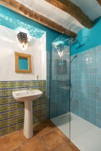 a bathroom with a shower, sink, and toilet at Atelier 88 Boutique B&B in Alcalá la Real