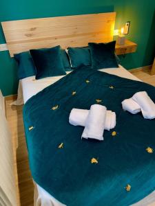 a bed with two pillows and butterflies on it at La Casa OM in Almorox +42 photos