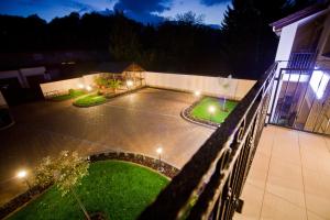 a view of a courtyard of a house at night at Levendula Apartmanház in Sárvár