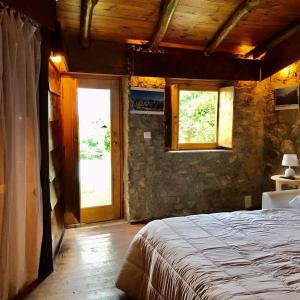 a bedroom with a bed and a window and a door at Quinta dos Carvalhos The Wine House Farm in Center of Lamego - Capital of the Douro in Lamego