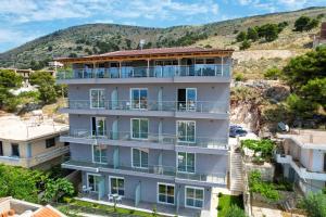 an image of a building with a hill in the background at Angel Saranda Palace in Sarandë