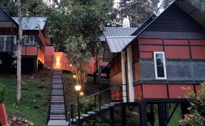 a house with a staircase leading up to it at Santhi Hill View Resort in Munnar