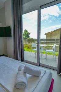 a bedroom with a bed and a view of a patio at Angel Saranda Palace in Sarandë +235 photos