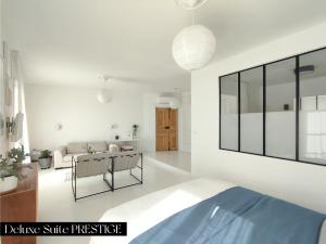 a living room with white walls and a large mirror at Le Prince - Maison d'hôtes in Marseillan