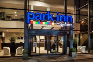 a dark inn sign in front of a building at Park Inn by Radisson Liege Airport in Liège