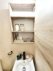 małą łazienkę z umywalką i półką w obiekcie Cute Suite Apt., close to metro and highway w Atenach +37 zdjęć