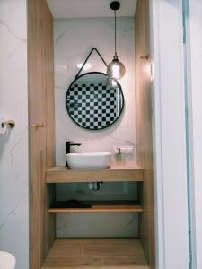 a bathroom with a sink and a mirror at Apartament Angel City SPA Silownia in Wrocław