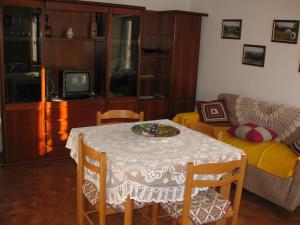 a living room with a table and a couch at Holiday home Maso Mersi in Castello Tesino