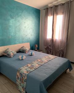 a bedroom with a bed with two pillows on it at Case Vacanza Zeus in Trappeto