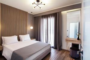 Postel nebo postele na pokoji v ubytování Villas Mandalos