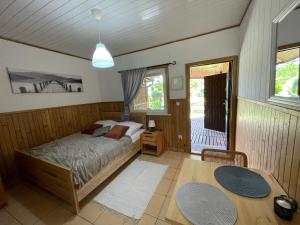 a bedroom with a bed and a table at Zarzecze 27A in Augustów