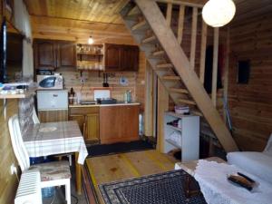 a small kitchen with a staircase in a cabin at Veličanka in Ulcinj
