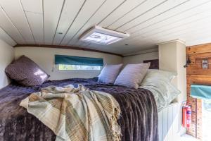 A bed or beds in a room at The Hoot Romantic Glamping